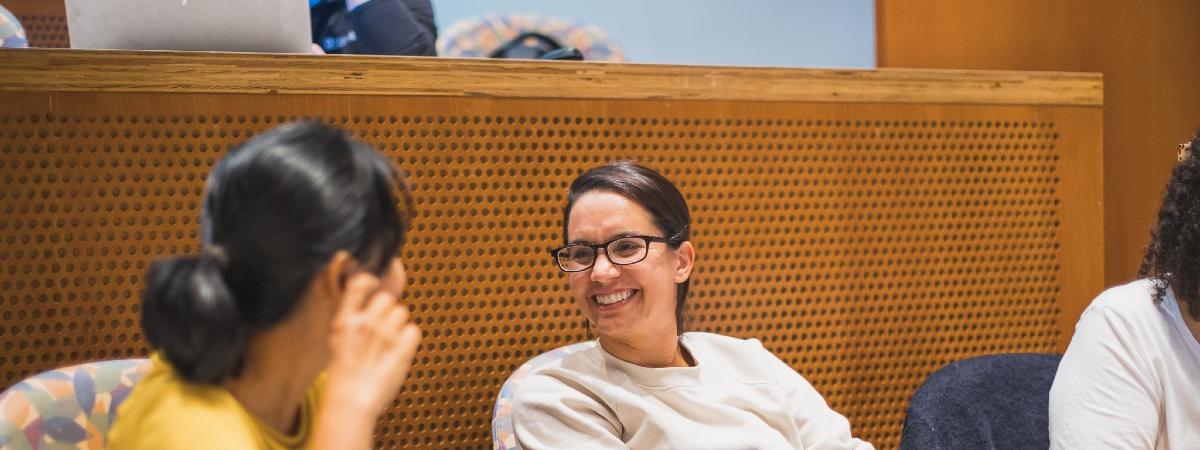 Two students laughing together in class